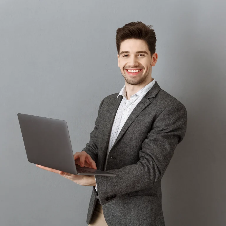 Guy standing and using a laptop while viewing Leo by role, highlighting role-based access and secure, approved answers